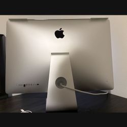 Mac Desktop 27” Apple keyboard, and mouse.