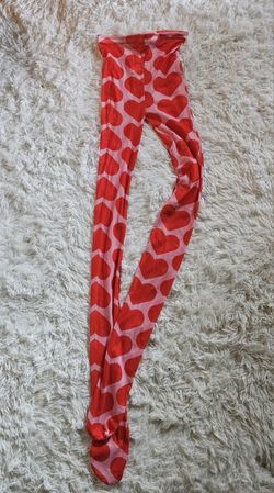 Stylish pink tights stockings with a bold heart pattern. Perfect for adding a fun touch to any outfit. Great with a skirt and a pair of boots. one siz