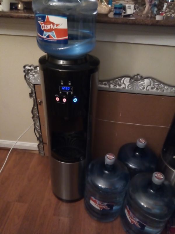 Water dispenser with a 5 gallon ozarka water for Sale in Houston, TX