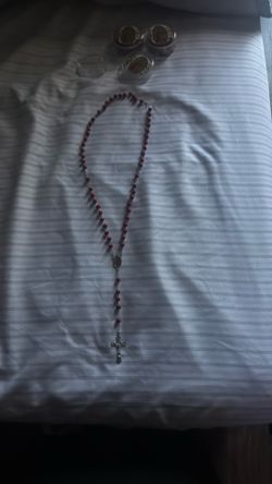 Red rosary with the Virgin Mary on it and with cross