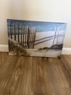Serene beach scene canvas wall art. This piece is a gallery-wrapped canvas print featuring a coastal landscape