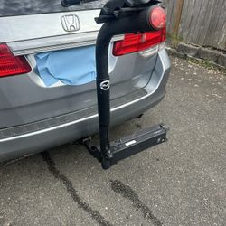 Two bicycle racks that fit behind the car