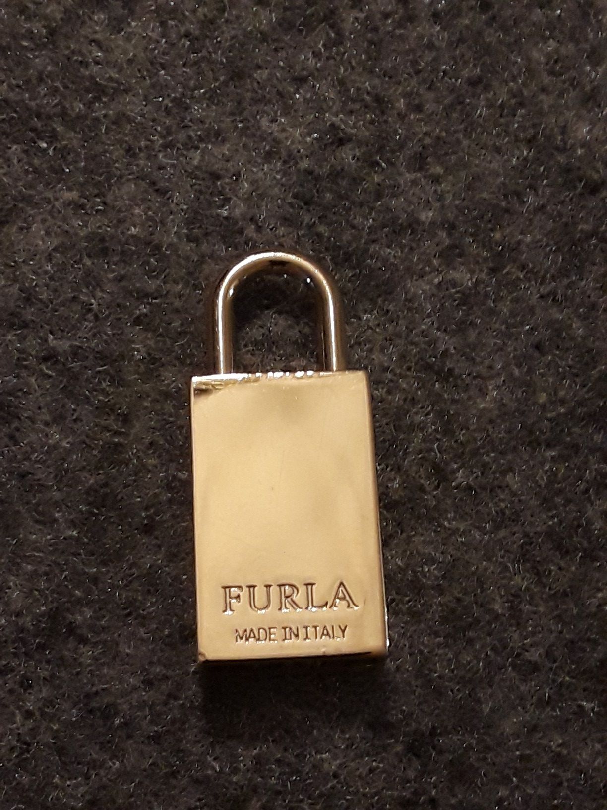 Top handle, padlock closure, logo stamped all over, gold…