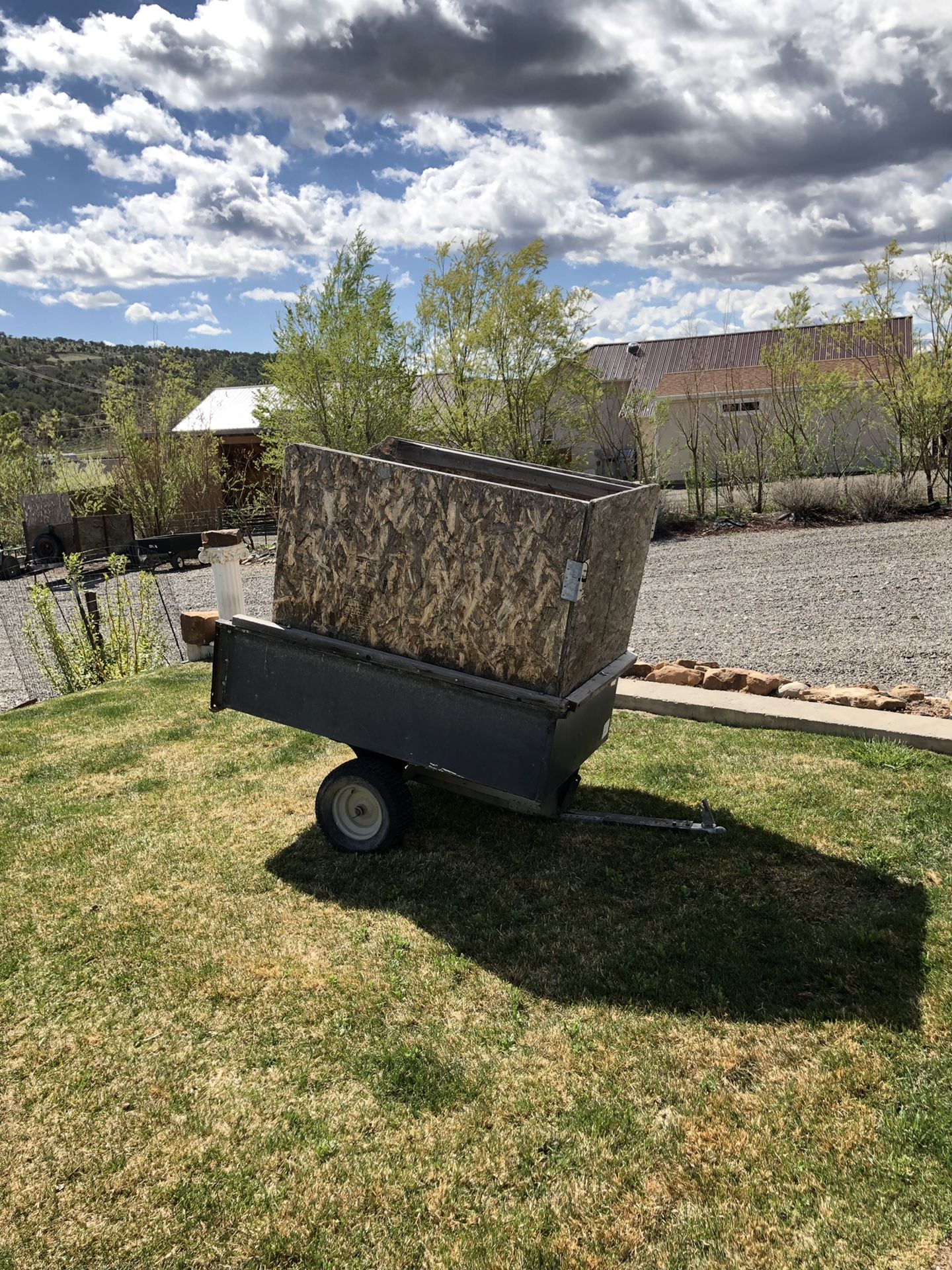 Photo Small 2 wheel utility trailer with removable wooden sides.