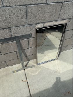 18” x 40” mirror with stainless steel frame and mount.