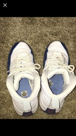 Pair of white and blue air Jordan’s 12’s