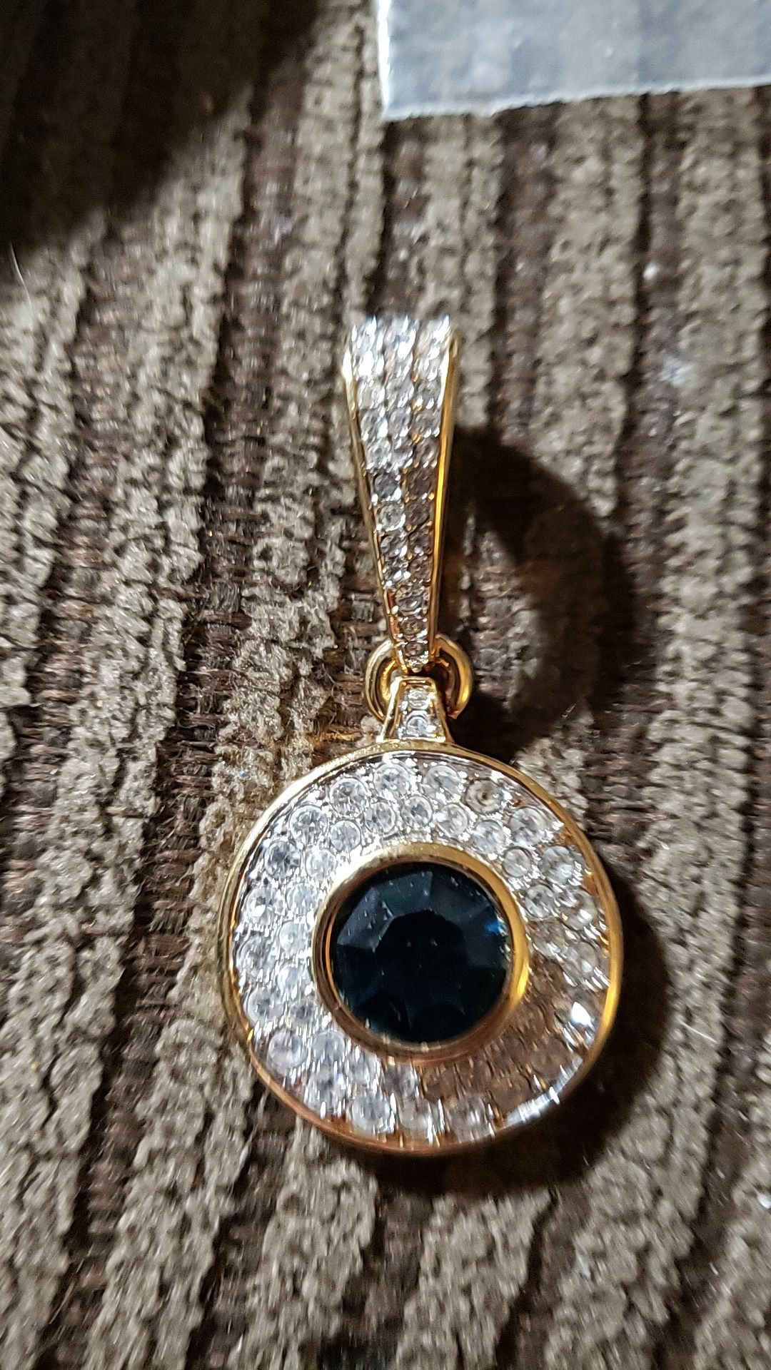 Swarovski Crystal gold tone pendant. Blue sapphire center stone and Crystal's all around