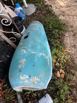 Large ceramic garden planter has a tapered bullet shape and a blue finish. This heavy-duty pot is made of a thick material and has a drainage hole at