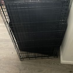 A Very Big Dog Cage With Locks On It And Tray 