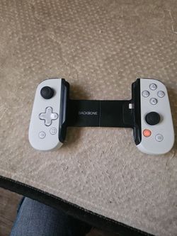 white Backbone One PlayStation Edition mobile gaming controller for iPhone.