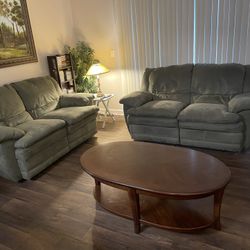 Two Reclining Love Seats By Ashley Furniture  And Coffee Table