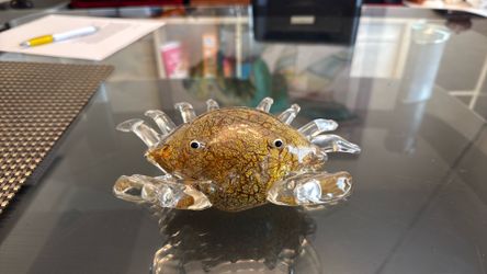 A hand-blown art glass crab figurine with amber and gold textured carapace.