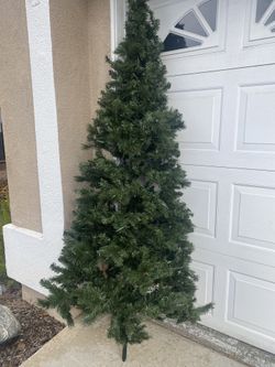 Selling A 7.5 ft Artificial  Christmas Tree With pre lite white Lights in working condition, still in good condition,  needs tree stand 