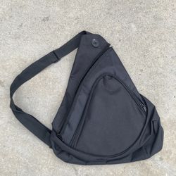 Honey Comb Sling Pack. Front Zipper Pocket, Main Compartment With A Zippered Side Entry. Audio Pocket With Headset Port