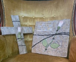 A pair of late 1990s faux-stone resin Christian wall plaques with rose and scripture details.