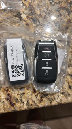 Two brand new key fobs for a Chrysler or Dodge