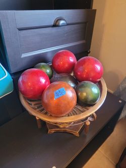 These are vintage bocce balls, often crafted from wood or composite materials like Bakelite.