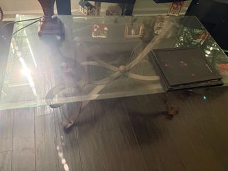Wrought iron and glass coffee table.26x50”.