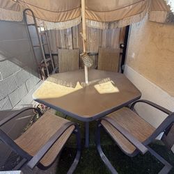 Sun table with four chairs and center umbrella