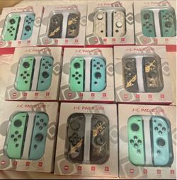New wireless J-C Pad controllers for Nintendo Switch. These controllers are available in mint green, white with patterns, and black with gold designs.