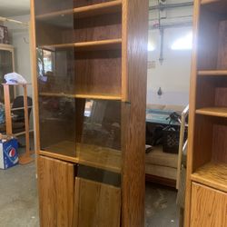 Wooden Cabinet With Glass Doors On Top And Wooden Doors At The Bottom