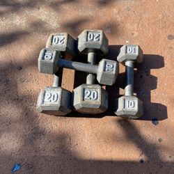 cast iron dumbbells, including pairs marked 10 lbs and 20 lbs.