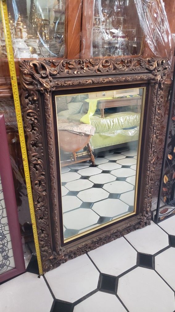 used antique looking carved wall mirror