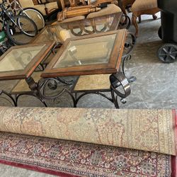 Set of glass top coffee tables and a rolled area rug