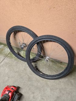 black bicycle wheels with pneumatic tires and thin metal spokes 26 inch