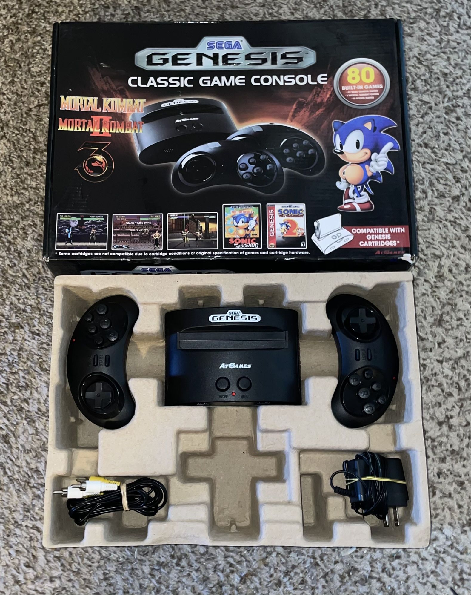 SEGA GENESIS AT GAMES CONSOLE WITH VIDEO GAMES CONTROLLER