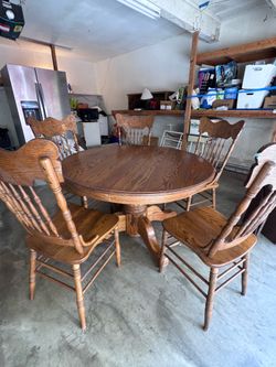 Wooden round table and five chairs.