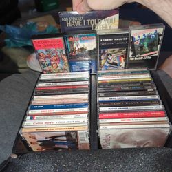 27 CDs And Four Cassette Tapes Of Varying Genre, From Country To Blues To Rock