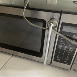 Samsung countertop microwave oven, likely a mid-size model in stainless steel. 