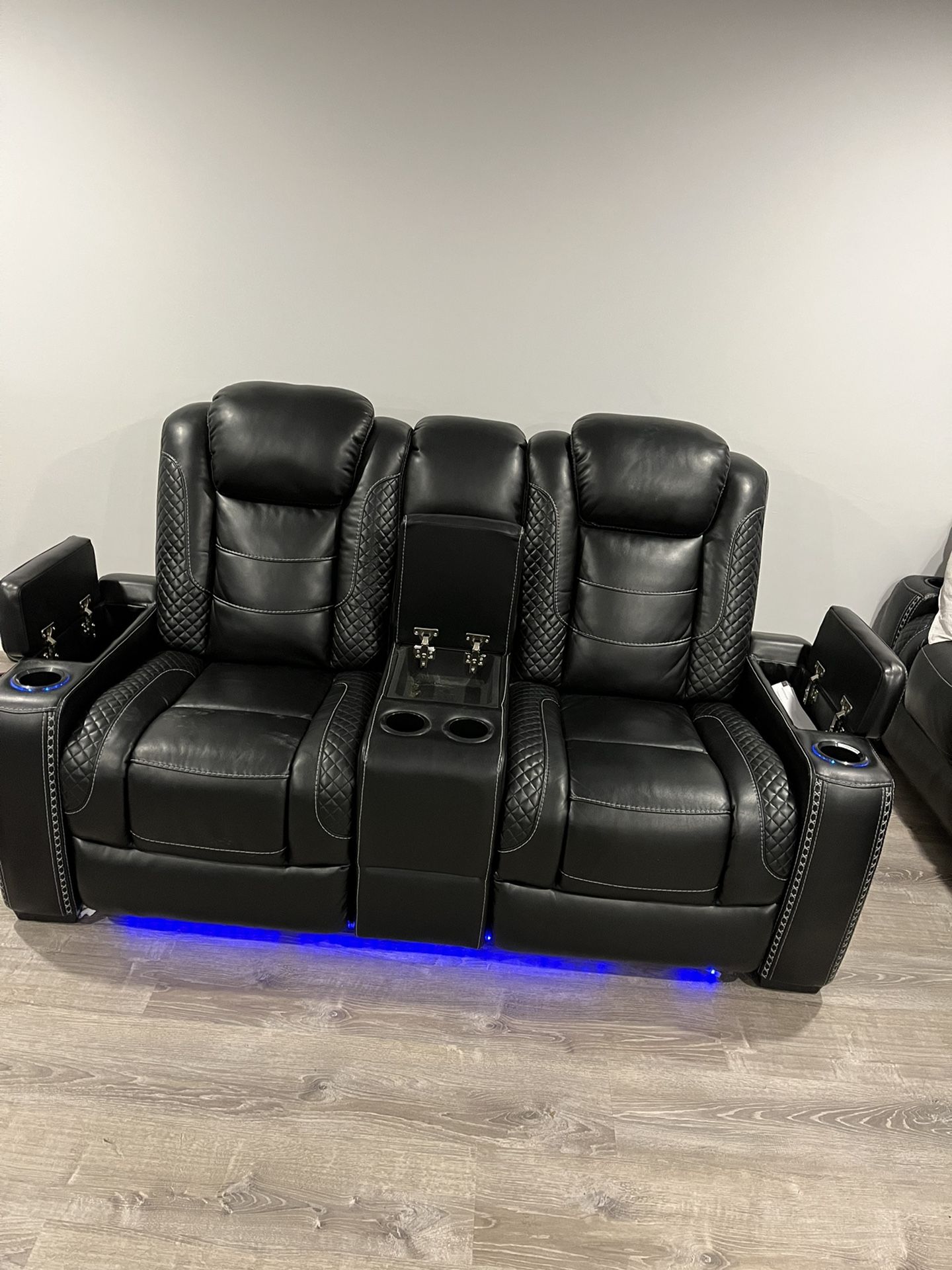 Power reclining sofa with adjustable power headrests. It has a fabulously modern look with midnight-colored polyester upholstery, cross hash stitching