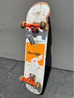 Skateboard / CHOCOLATE CO.  ROYAL tRUKS / nEON OrANGE/ 52 mm WHEELS 32” in X.  7.75. BOARD.