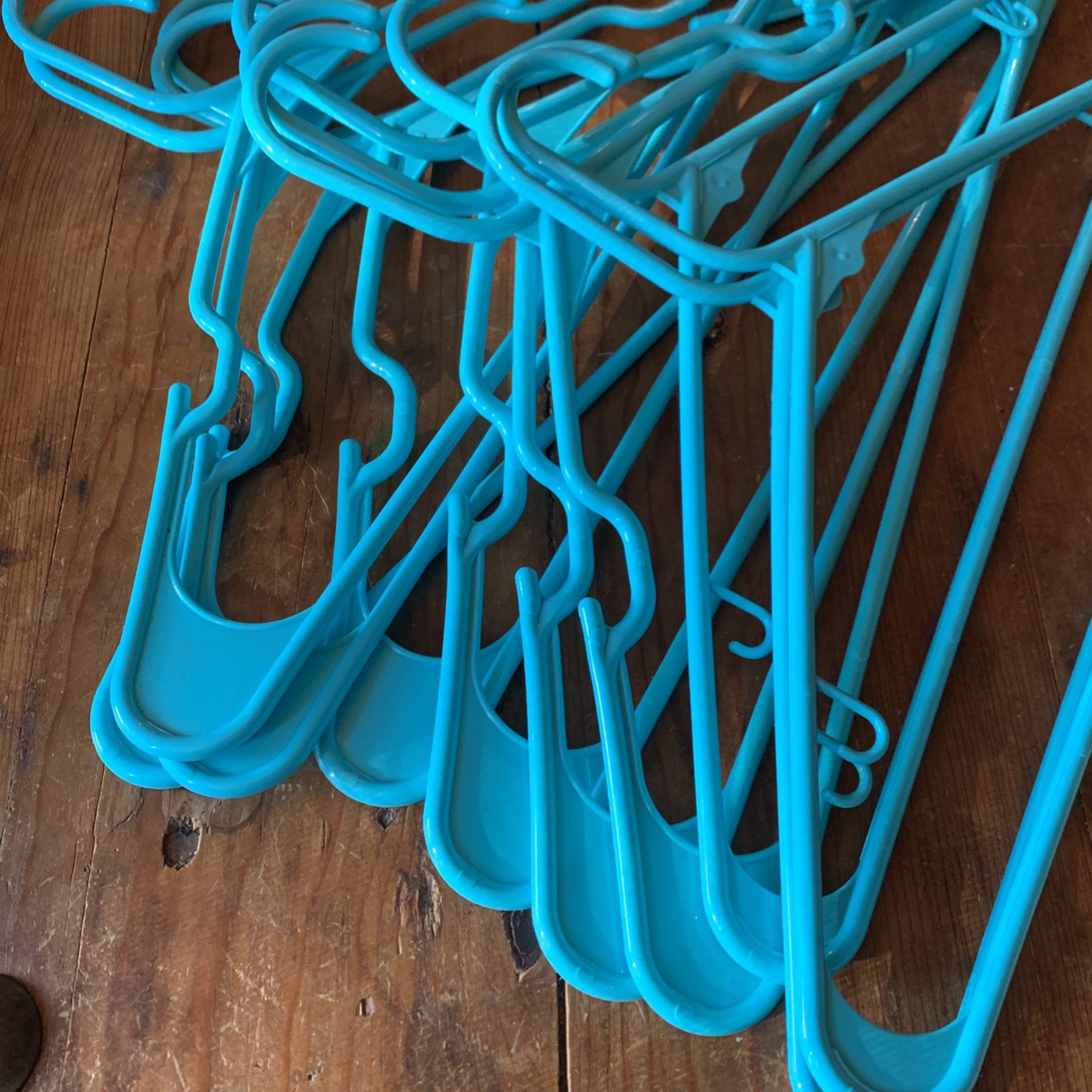 One Dozen Turquoise Plastic Hangers 