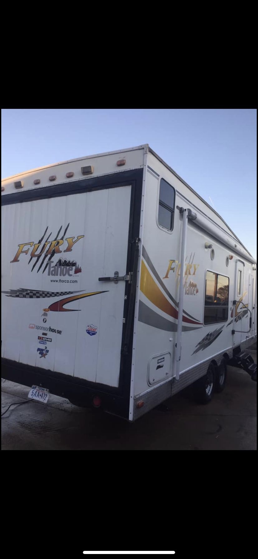 2004 travel trailer Fury Tahoe toy Hauler 26ft two queen size power electric bed two fold out couches turn into beds sleep 6 fridge Central AC and h