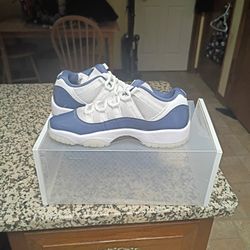 Jordan 11 Retro Low in the "Diffused Blue" colorway, featuring a white ballistic mesh upper with a glossy patent leather overlay. 