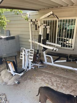 Multi-station home gym with weight stack.