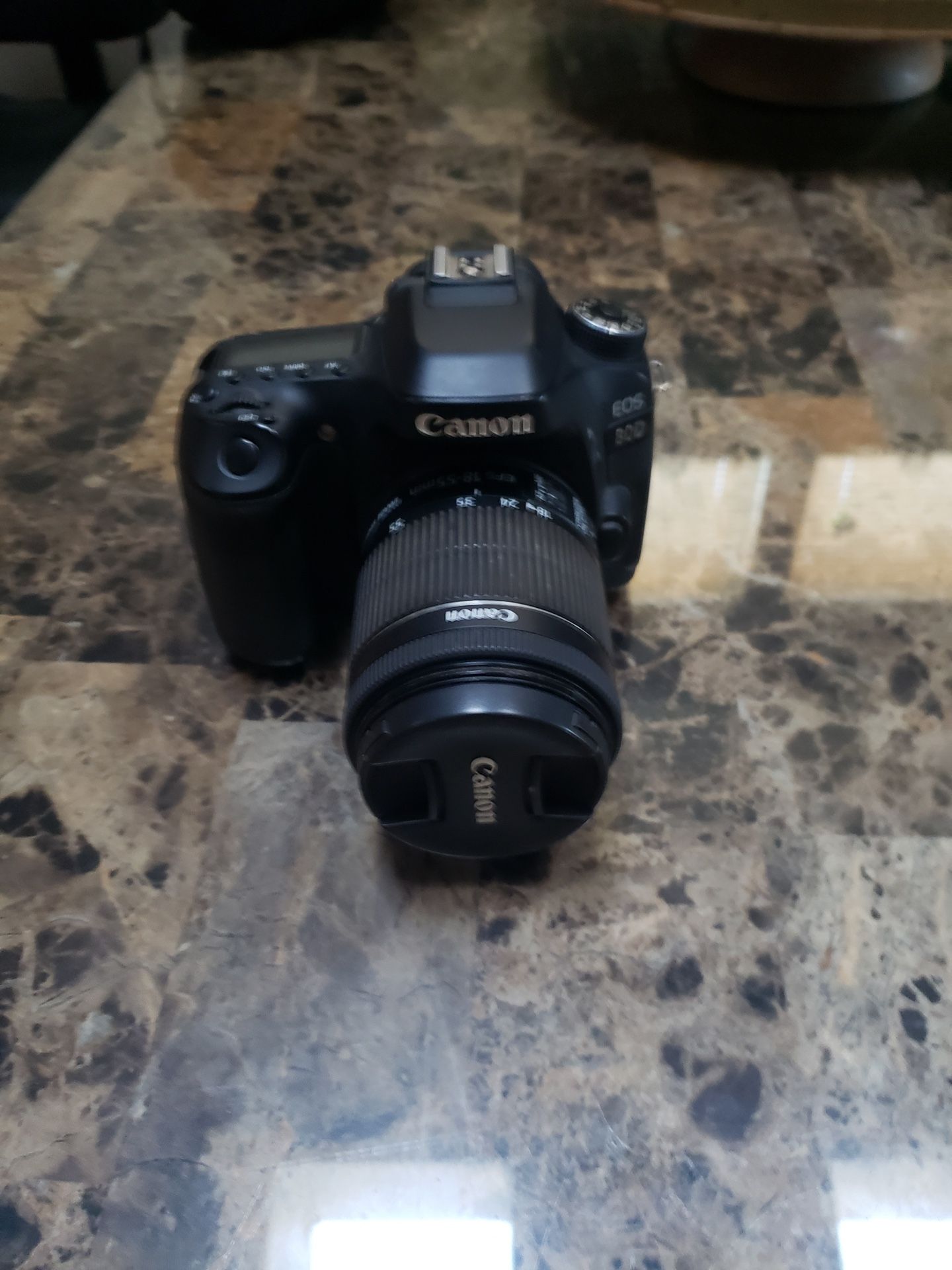 Canon EOS 80D DSLR camera with an EF-S 18-135mm lens.