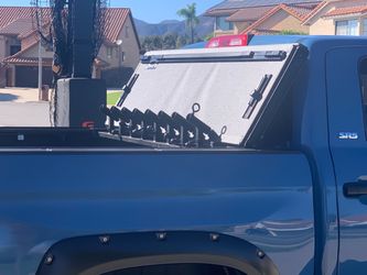 Fishing rod holder mounts to truck bed.