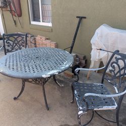 Solid Cast 48" Diameter Table And Two Chairs
