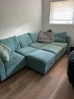 Light Blue couch, lots of storage space, reconfigurable