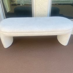 modern upholstered accent bench or "bouclé curved bench"
