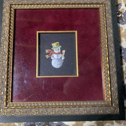 Framed decorative art featuring a snowman with vintage Frame