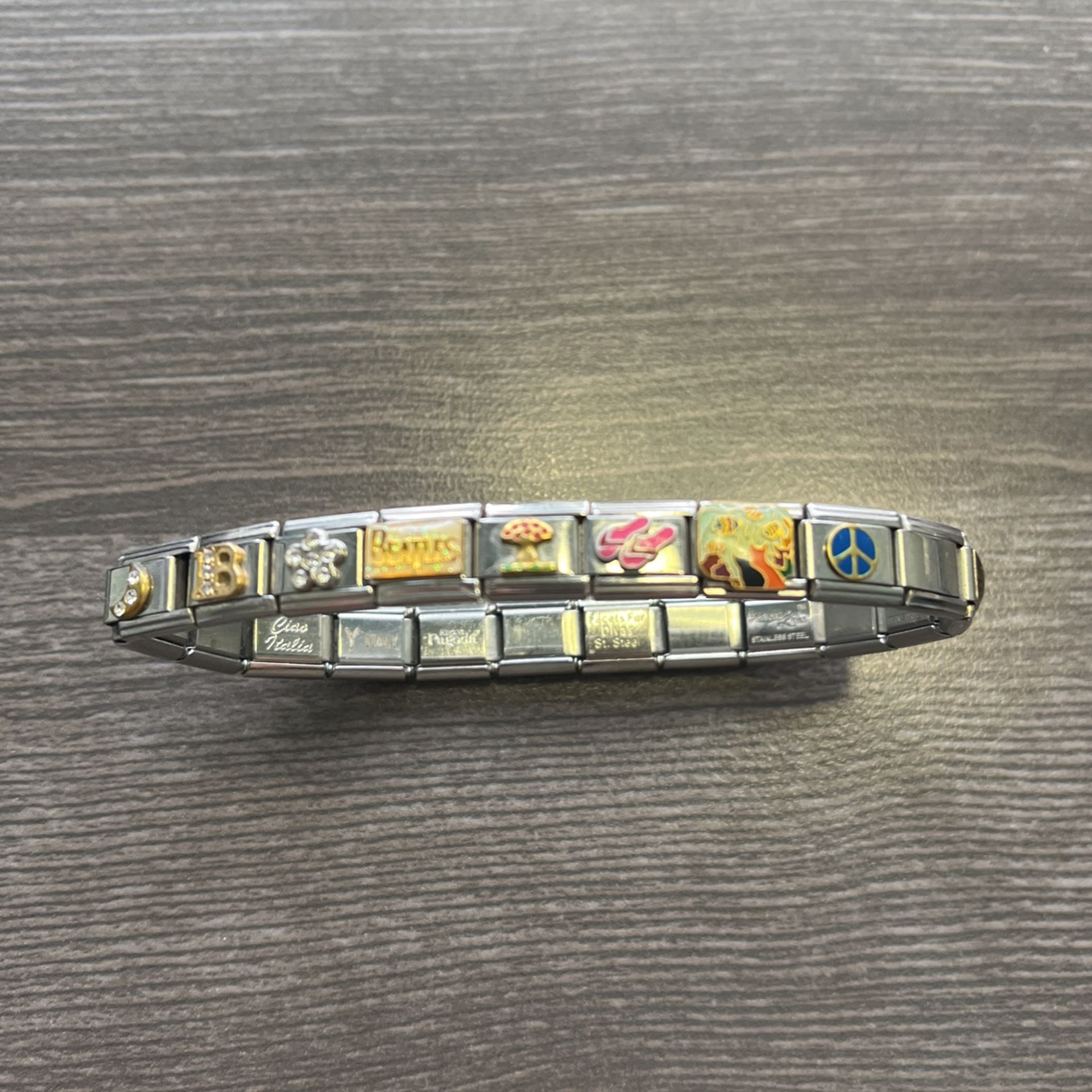 Vintage loaded charm bracelet. 18 charms - 18k gold and stainless steel. Like new condition