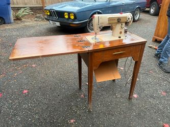 Vintage singer model 223 sewing machine with fold out cabinet table