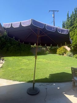 Outdoor umbrella with stand