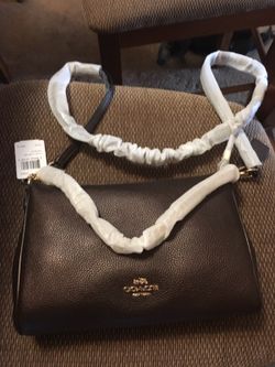 Authentic Coach cross body with chain detail. Brand new with tags. MSRP $295 plus tax.