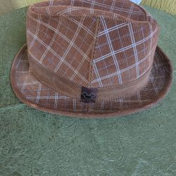 Disneyland brown corduroy fedora hat featuring a plaid pattern and a small Mickey Mouse icon on the band. 